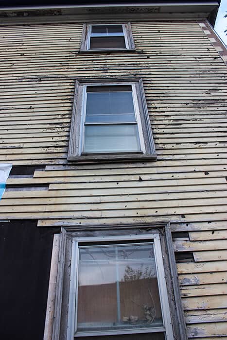 Up close three windows of the Grimshawe House in Salem