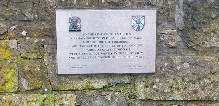 A plaque showing that the wall was repaired in 1988 by the Council of Edinburgh.