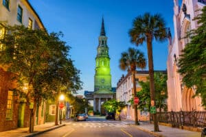 Imagine going on one of the best ghost tours in Charleston South Carolina! The historic buildings surrounded by palm trees at night.